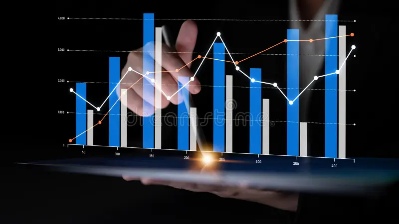 Hand holding a tablet with digital graphs and data analysis